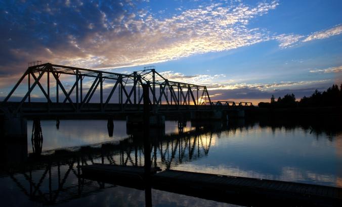 Trestle bridge at sunset over the San Joaquin River in Central Valley, California.