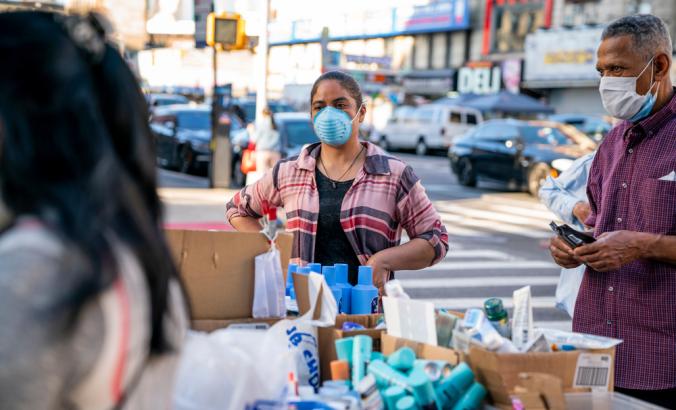 Person wearing a mask sells beauty products at a street stall in Washington Heights, Manhattan in New York City during the COVID-19 pandemic.