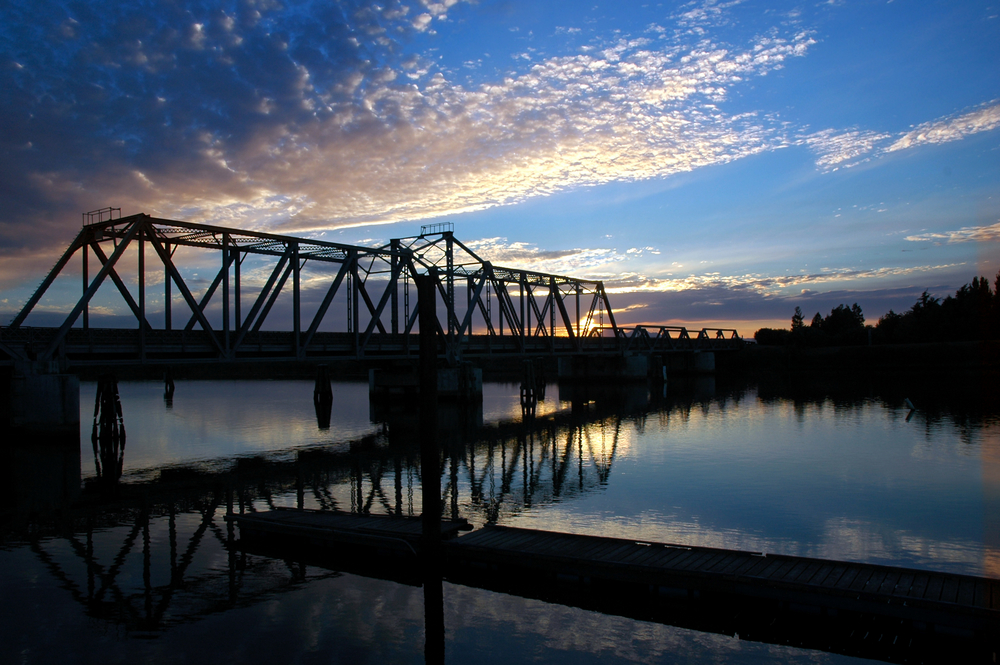 Trestle bridge at sunset over the San Joaquin River in Central Valley, California.