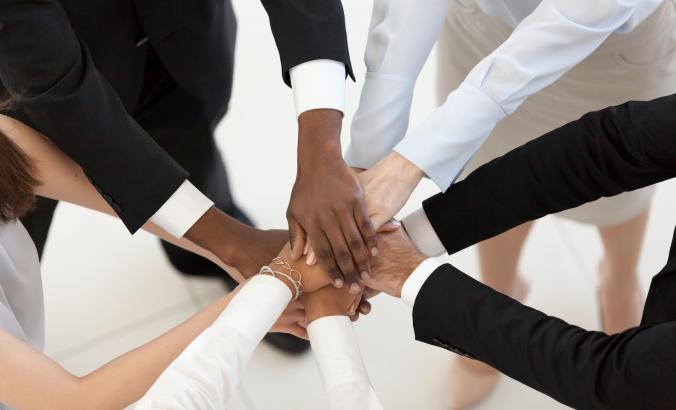 diverse hands coming together
